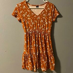 An orange brown dress with flowers